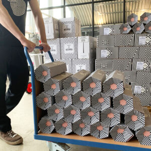 branded stacked rollor bottles with wine bottles in Neleman's warehouse creating a honeycomb pattern